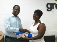 Mr. Keilan Johnson - Sales Manager at Green Dot (left), Ms. Kathleen Jacob - Winner of One Month Free Digital Cable TV (right)